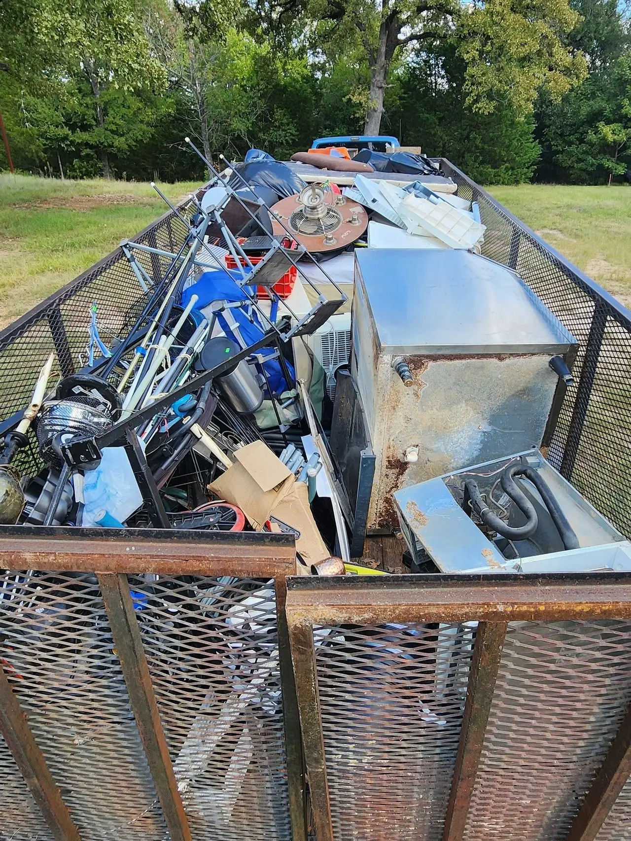 HCC's trailer loaded with removed appliances and household items on a job in Henderson County