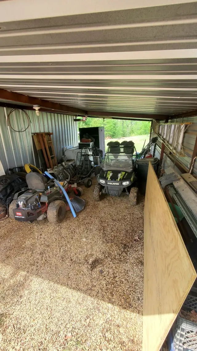 Interior of a metal shop on acreage with machinery and equipment awaiting removal