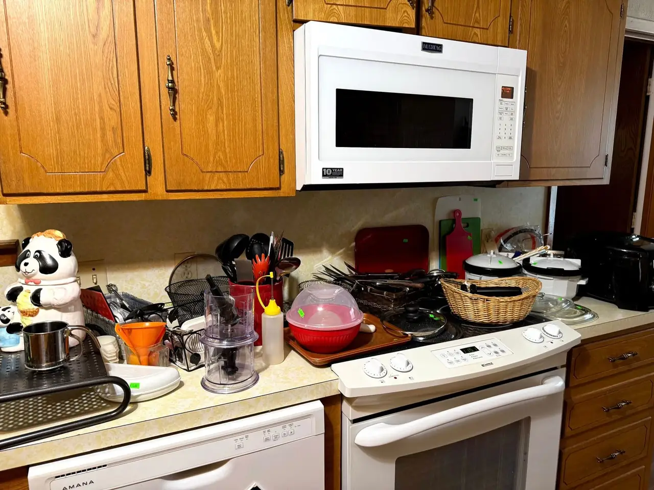 A kitchen counter in a Henderson County home covered end to end with small appliances, cookware and utensils before clearing