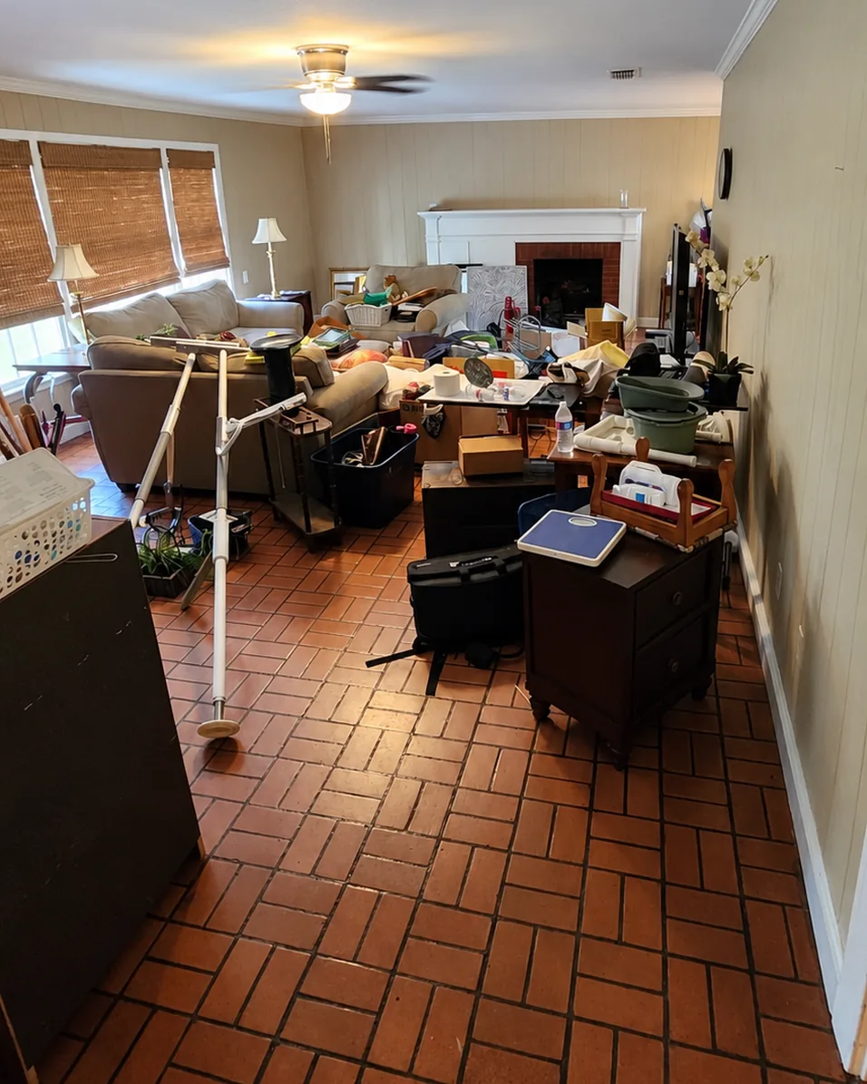 Living room filled with furniture, boxes and household belongings before the cleanout; camera angle aligned with AI