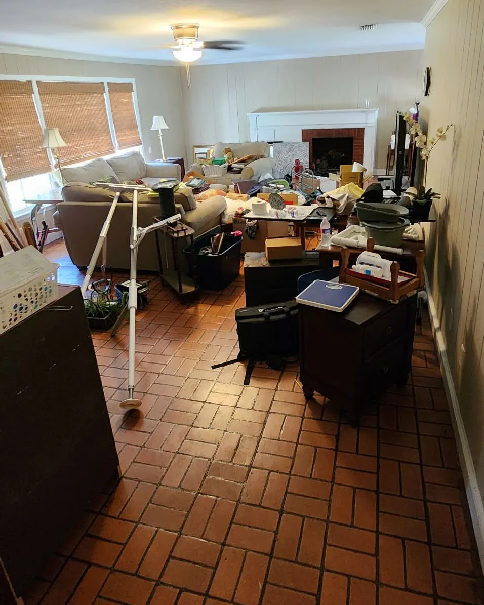 Living room with furniture, boxes and household belongings before the cleanout